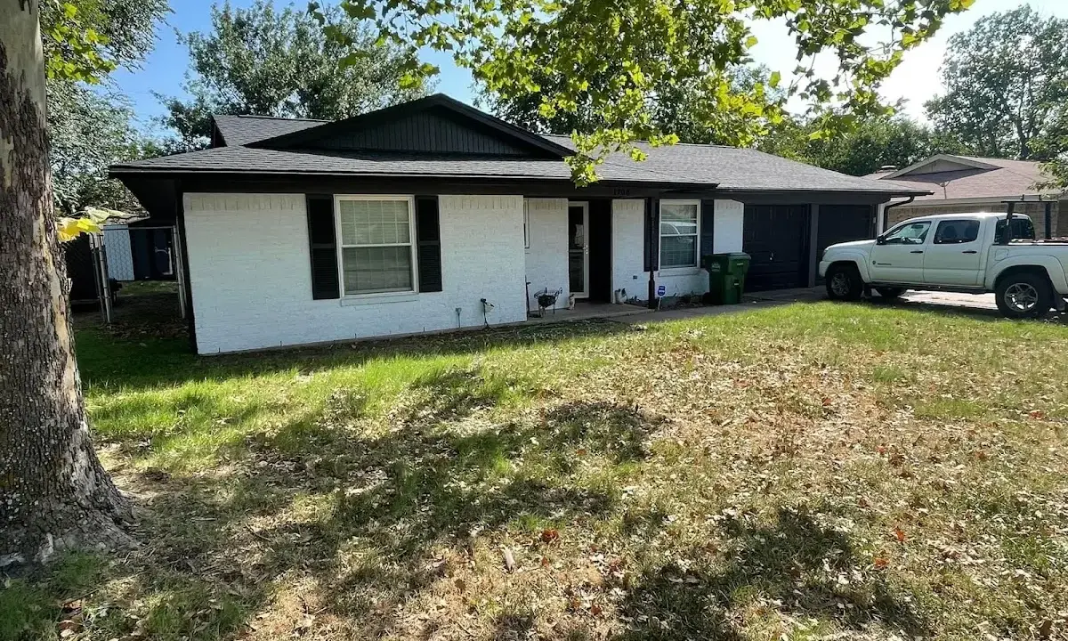 Professional roofing crew working on a residential roof in Easton